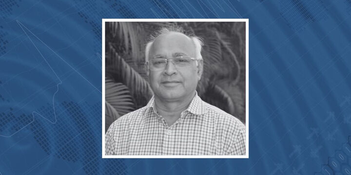 Photo of Prof. Shyam S. Rai against a background showing a spiky seismograph