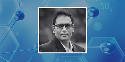 Prof. Pinaki Talukdar's photo against a background representative of chemistry or chemical structures