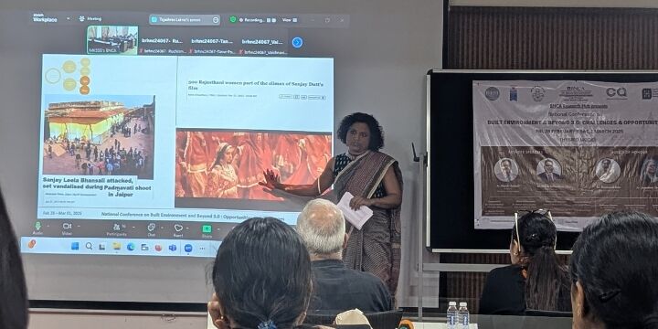 Photo shows PhD student Tejashree at the stage making a presentation with a few members of the audience seen in front of her